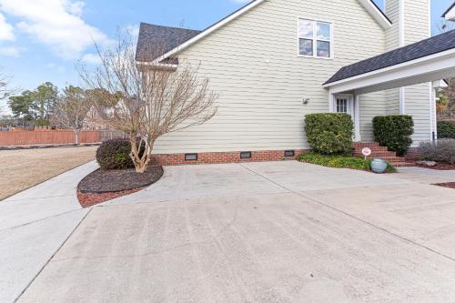 a house with a driveway in front of it at Amazing Home w/ Huge Pool, Game Tables, Movie room, and More! in Fayetteville