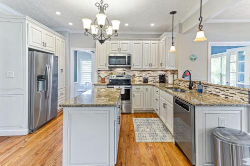 a kitchen with white cabinets and stainless steel appliances at Amazing Home w/ Huge Pool, Game Tables, Movie room, and More! in Fayetteville