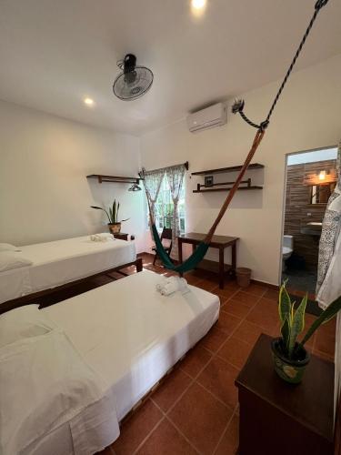 a room with two beds and a hammock in it at Casa Lomas del Marinero Internet Starlink SIN GARAJE in Puerto Escondido
