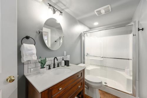 a bathroom with a shower and a toilet and a sink at Beautiful, Historic Home, heart of McMinnville. in McMinnville