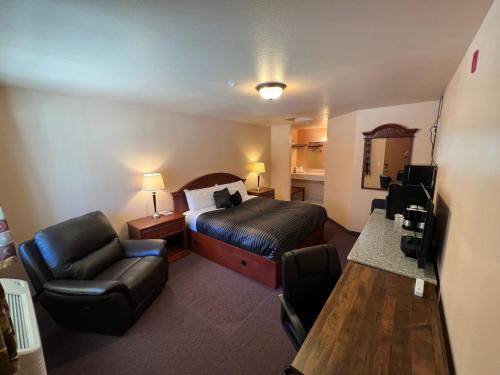 a hotel room with a bed and a chair at Frazier View Motel in Frazier Park