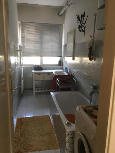 a bathroom with a tub and a sink at Sarajevo, Lovely two bedroom apartment in the very center in Sarajevo