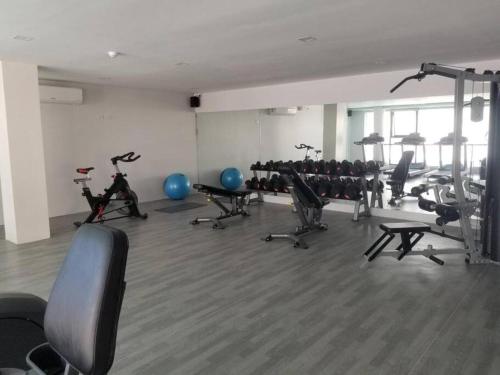a gym with a bunch of exercise bikes and exercise balls at Spacious 2 bedroom 42sqm condo unit in Iloilo City