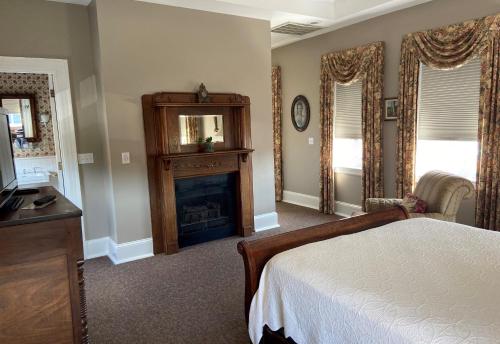 a bedroom with a bed and a fireplace at Bluff View Inn in Chattanooga