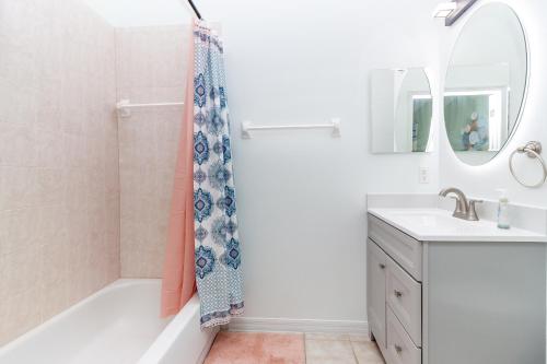 a bathroom with a shower curtain and a sink at Gorgeous Fully Furnished 2-Bedroom Luxury Villa in Kissimmee