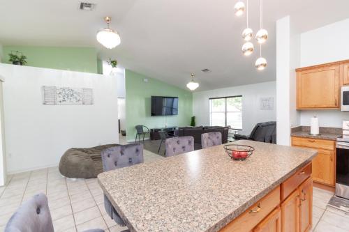a kitchen and living room with a table and a couch at Gorgeous Fully Furnished 2-Bedroom Luxury Villa in Kissimmee