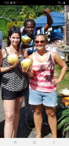 a couple of women standing next to a man at Berkey's Jungle Paradise in Roseau