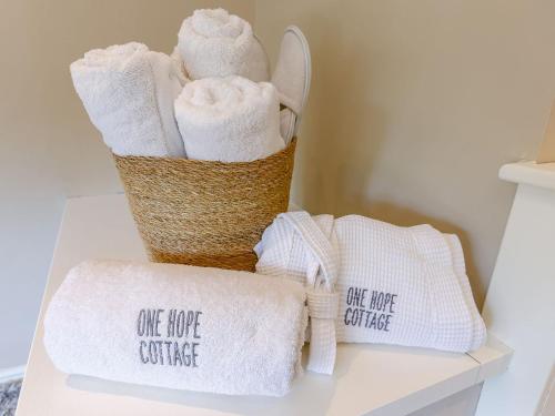two baskets of towels with one hope conference written on them at Hope Cottage in Longborough