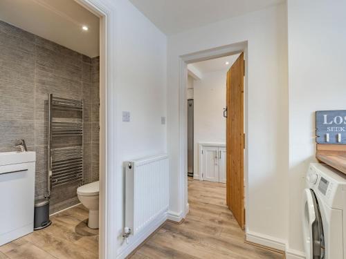 a bathroom with a toilet and a walk in shower at The Old Farmhouse in Longford