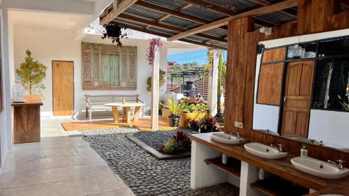 a bathroom with two sinks and a patio at Chakra Tavern in Bedugul