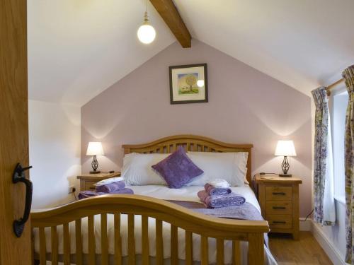 a bedroom with a bed with a teddy bear on it at Shepherds Den in Crakehall