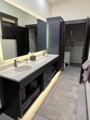 a bathroom with a sink and a large mirror at Whitefish Slopeside Condo in Whitefish