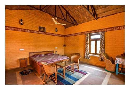 a bedroom with a bed and a table and chairs at Mahua hill view Homestay in Orchha