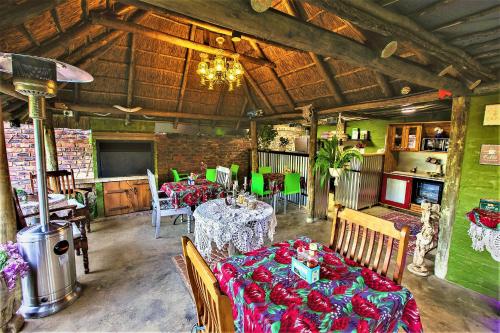 a dining room with tables and chairs in a building at The Ranch Guesthouse in Potchefstroom