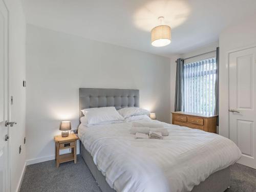 a bedroom with a large white bed with two glasses on it at Studio - Uk34126 in Tewkesbury