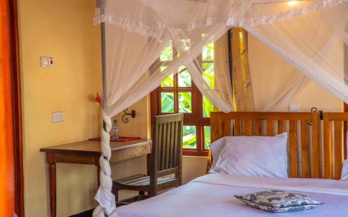 a bedroom with a bed and a window at Christina House in Arusha