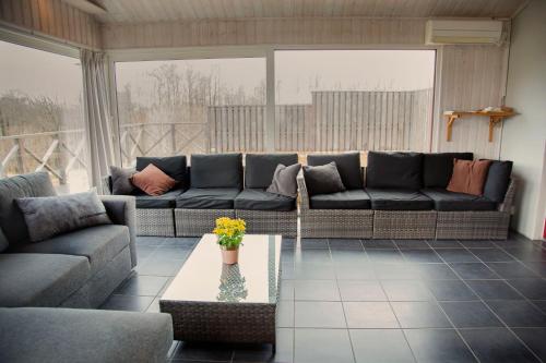 a living room with a couch and a table at Hotel Bella Luna in Båstad
