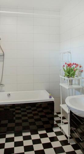 a bathroom with a tub and a sink and a toilet at Hotel Bella Luna in Båstad
