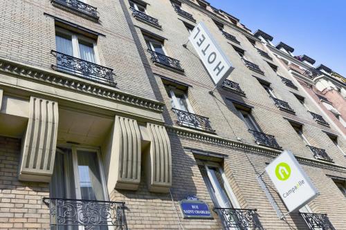 a large brick building with a hotel sign on it at Campanile PRIME - Paris 15 Tour Eiffel in Paris