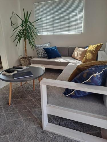 a living room with a couch and a table at Sterrenhemel Guest Farm in Upington