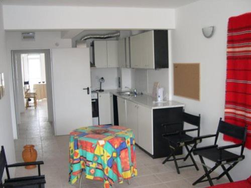 a kitchen with a table and chairs in a room at 6 Treti Mart street 2 floor in Primorsko