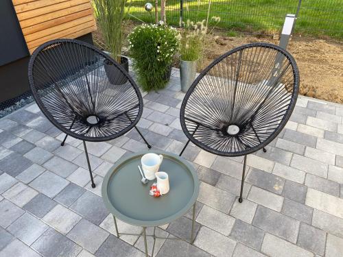 two chairs and a table on a patio at Fichtelcube de in Schönwald