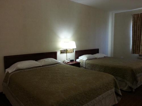 a hotel room with two beds and a lamp at Super 8 by Wyndham Page/Lake Powell in Page