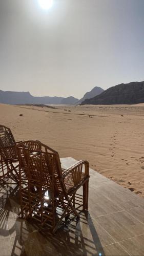 a group of chairs sitting in the middle of the desert at Rum Jordan camp and tours in Wadi Rum