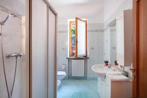 a bathroom with a sink and a toilet and a mirror at Casa Marcella in Gaiole in Chianti