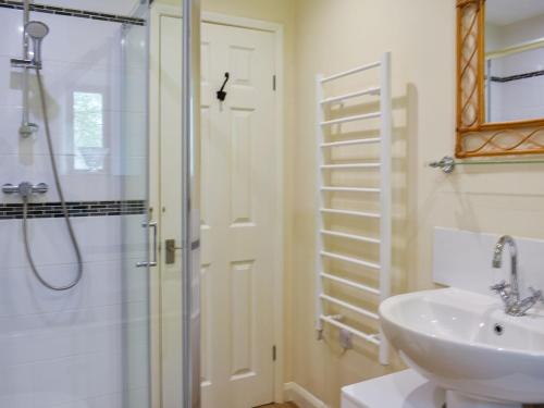 a bathroom with a shower and a sink at Cherry Barn in Dufton