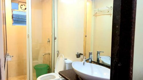 a bathroom with a sink and a toilet and a shower at CANDOLIM BEACH VILLA # 3BHK # POOL # KITCHEN # 300Mts to Beach by GR stays in Candolim