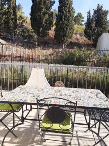 a table and chairs on a patio with a skate park at villa aurora in Giardini Naxos