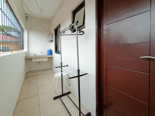 a room with a door and a hallway at Manzil Anilao B&B in Mabini