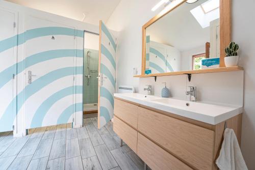 a bathroom with a sink and a mirror at GARDEN - Utopy Hostel in Biarritz