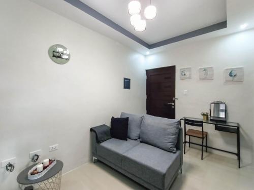 a living room with a couch and a table at Manzil Anilao B&B in Mabini