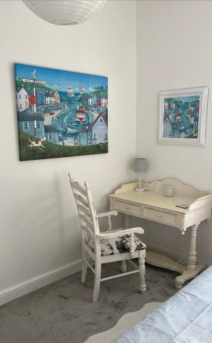 a bedroom with a desk and a chair next to a piano at Avocet House Hunstanton 250m from the sea in Hunstanton