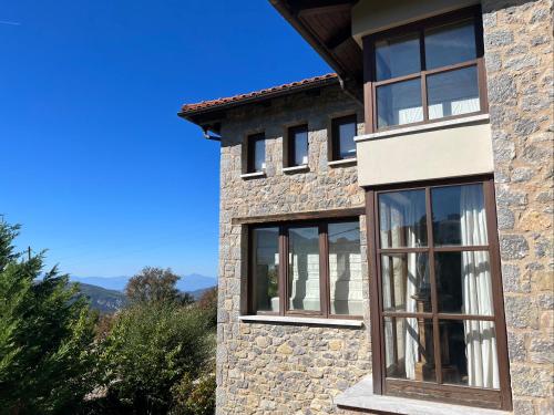 a stone house with two windows on the side of it at Plethora Arachova Luxury Chalet in Arachova