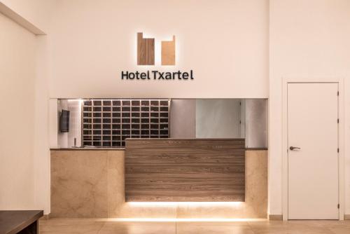 a lobby with a hotel market sign on the wall at Hotel Txartel in Lasarte
