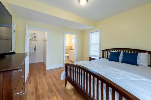 a bedroom with a large bed with blue pillows at 90-Boston Spacious Convenient Apartment in Boston