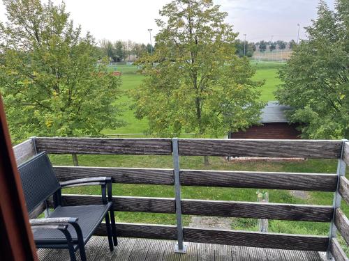 a bench on a deck with a view of a field at Bennstedt 1 in Salzatal