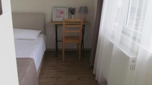 a bedroom with a bed and a desk with a chair at Hotel Classic in Tʼelavi