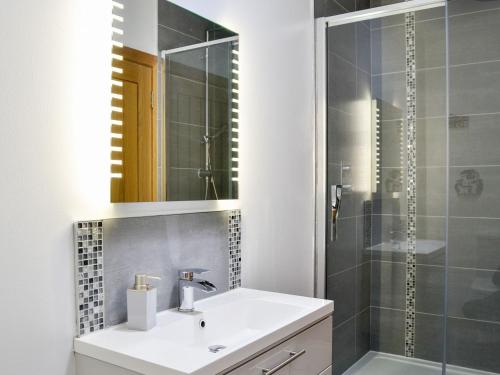 a bathroom with a sink and a shower at Eleanor Cottage in Ballater