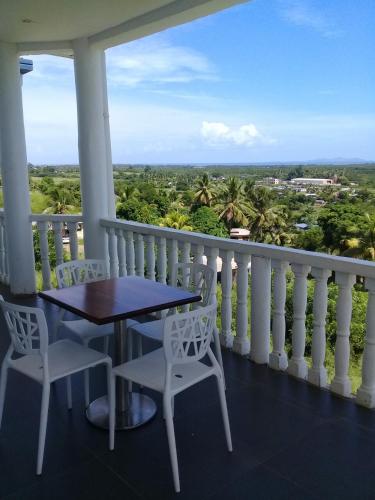 a table and chairs on a balcony with a view at Best View Apartments in Nadi