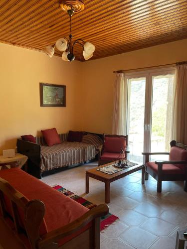 a living room with a couch and a table at Thanasis house in Dhimitsana