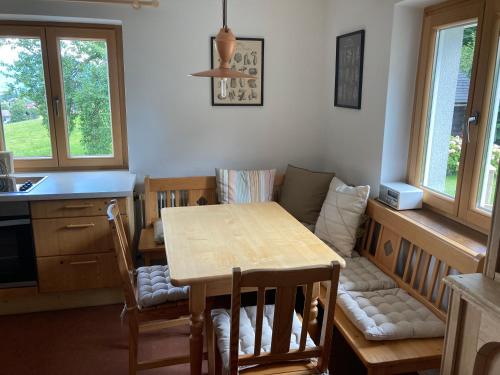 a kitchen with a table and chairs and a dining room at Ferienwohnung Schwarzindien in Mondsee