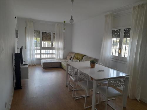 a living room with a table and a couch at Casa Antoniet de la llum in Riumar