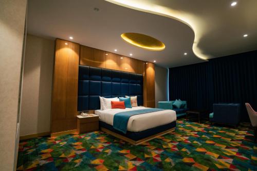 a hotel room with a bed and a couch at Ramada Plaza by Wyndham Jammu Vijaypur in Jammu