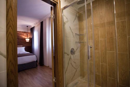 a bathroom with a walk in shower next to a bedroom at Pera Line Hotel in Istanbul