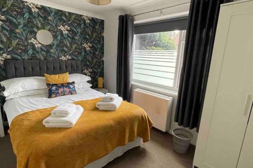 a bedroom with a bed with towels on it at Cayton village hide away in Cayton