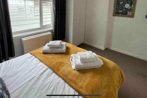 two towels on top of a bed in a room at Cayton village hide away in Cayton